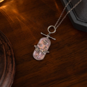 Macro detail of silver vintage bee pendant with pink enamel and OT toggle clasp