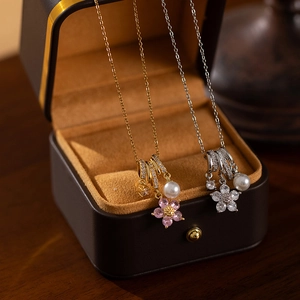 Floral zircon and pearl necklace in gold and silver finish shown in premium gift box