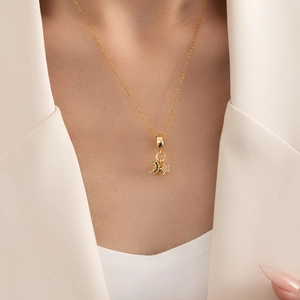 Elegant gold celestial necklace featuring a black zircon moon and a white star pendant