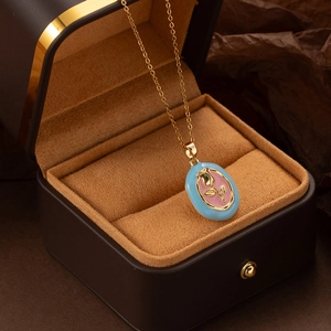 Detailed close-up of retro oval tulip pendant with pink enamel rose and golden chain