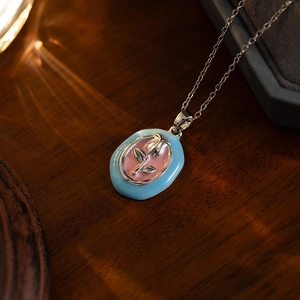 Macro detail of tulip pendant with blue and pink enamel and vintage rose relief
