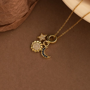 Chic gold celestial necklace with sun star and moon pendants set with zircon crystals