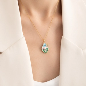 French style gold floral enamel pendant necklace with butterfly detail on female model