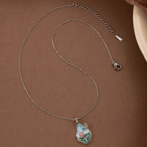 Elegant tulip flower pendant necklace with butterfly detail on vintage background