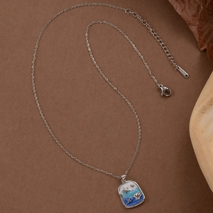 Silver stainless steel ocean necklace featuring starfish and shell blue enamel pendant