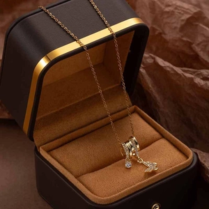 Detailansicht einer goldenen Schmetterling-Halskette mit Zirkonia-Inlay auf einer Box