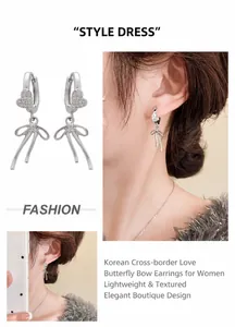 Detail of silver bow earrings with sparkling heart-shaped stud shown on a model