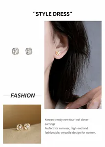 Detailed view of four-leaf flower earrings with gold frame, zircons and white pearls