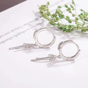Silver bow hoop earrings with micro-pave zircons shown from a professional side angle