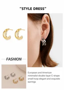 Detail of double-layer C-shaped earrings in gold and silver finish on model