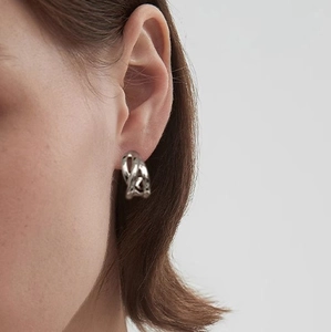 Minimalist double-layer C-shaped silver knot earrings shown on a model for modern style