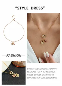 Détail du collier cœur doré avec zircon violet et pendentif patte sur la clavicule