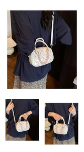 Detail of white quilted Boston bag with pearl beads and glossy patent finish