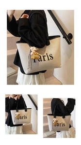 Detailed views of off-white canvas bucket bag with black leather trim and bear charm