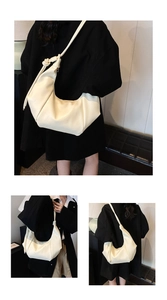 Detailed views of a creamy soft leather crossbody bag with knotted strap and slouchy design