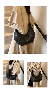 Detail of black pebbled leather texture on a minimalist hobo shoulder bag for women