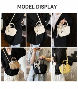 Detail view of versatile women handbag with lace bow and pearl chain in four colors