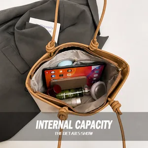 Top view of large khaki leather tote bag interior showing spacious capacity and zip pocket