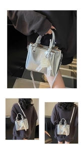 Detailed views of silver metallic bucket bag with pearl charm and lace ribbon accents