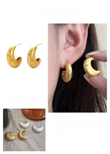 Detail view of crescent earrings with frosted finish and sparkling mini rhinestones