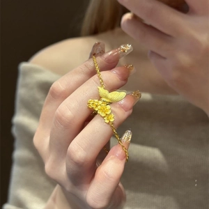 Brushed gold butterfly and flower bracelet for women in a vintage asymmetrical luxury style