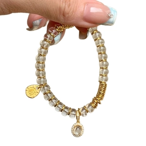 Elegant white crystal beaded bracelet with gold pendants and Chinese shuan character charm
