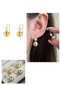 Detailed view of teardrop pearl drop earrings in gold and silver finish options