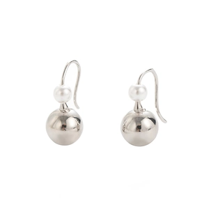Detail view of minimalist silver teardrop earrings with pearl bead and polished metal orb