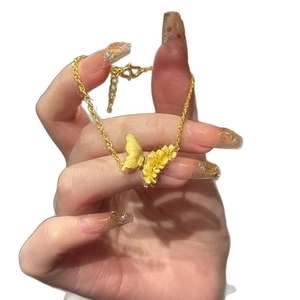 Golden brushed butterfly and floral charm bracelet for women with adjustable chain