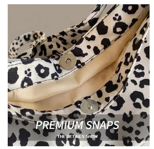 Detail of the high-quality magnetic closure on a leopard print canvas tote bag