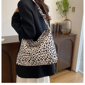 Close-up of leopard print canvas tote bag with seamless integrated shoulder strap design