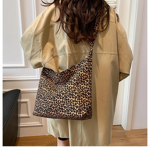 Close-up of leopard print canvas tote bag featuring wide strap and high-capacity design