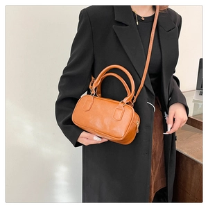 Sac à bandoulière vintage marron sur modèle avec sangle ajustable et doubles poignées