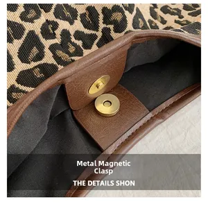 Detail of leopard print tote with magnetic gold snap button and brown leather trim