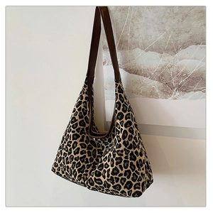 Detail of leopard print tote bag showing thick fabric texture and brown leather straps