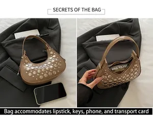Detail view of khaki crescent bag with silver rivets and spacious main pocket interior