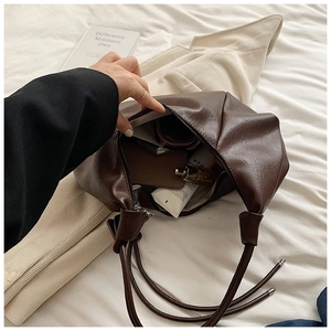 Deep brown pleated faux leather shoulder bag showing spacious interior and soft texture