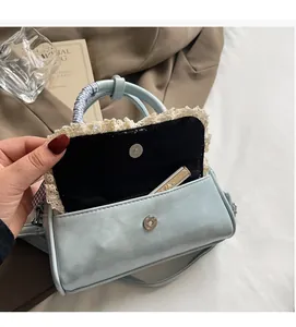 Detail view of light blue bowling bag interior with magnetic clasp and lace trim