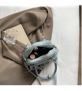 Top view of a light blue crossbody bag showing its spacious interior for cosmetics