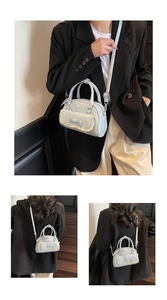 Detailed view of light blue lace bowling bag with ribbon bow and checkered scarf detail