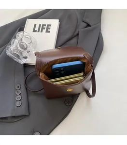 Internal view of brown vintage messenger bag showing space for phone and wallet