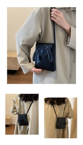Close-up of a black crossbody phone bag with cute 3D animal ears and star eyes detail
