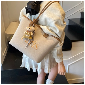 Canvas tote bag with Paris embroidery, brown leather trim, and cute bear charm