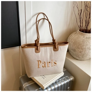 Chic canvas bucket bag with brown leather trim and Paris embroidery for travel