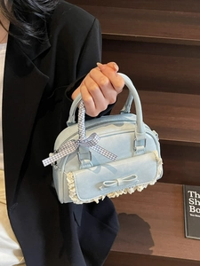 Elegant light blue small square handbag with lace bow detail and ribbon-wrapped handles