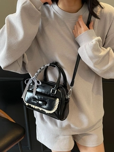 Chic black mini crossbody bag with white lace trim and checkered ribbon handle