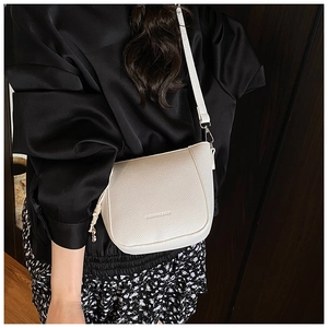 Detail of ivory lychee grain leather crossbody bag with Fashion Bags logo engraving