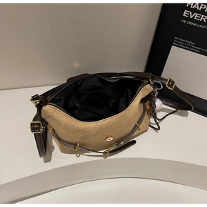 Détail du sac bandoulière en toile avec finitions en cuir et poche de rangement