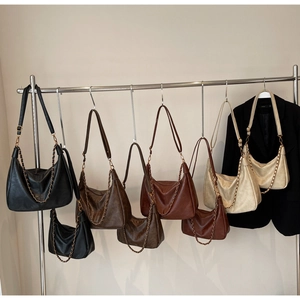 Row of minimalist vintage PU leather tote bags with metal chain straps in earthy colors