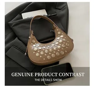 Detailed close-up of retro camel leather hobo bag with vintage silver rivet studs